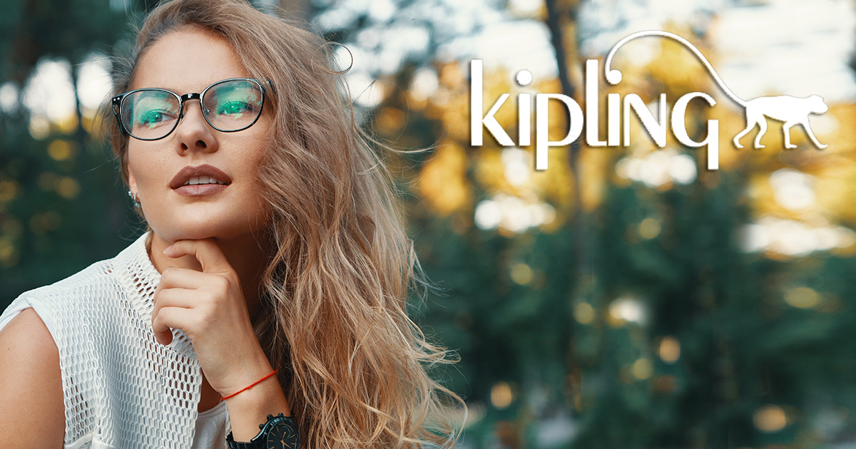 Gorgeous eyewear model.  Attractive woman wearing glasses, touching chin with hand while smiling, looking at camera, wearing white trendy clothes, blond curly hair. Beautiful human face features.