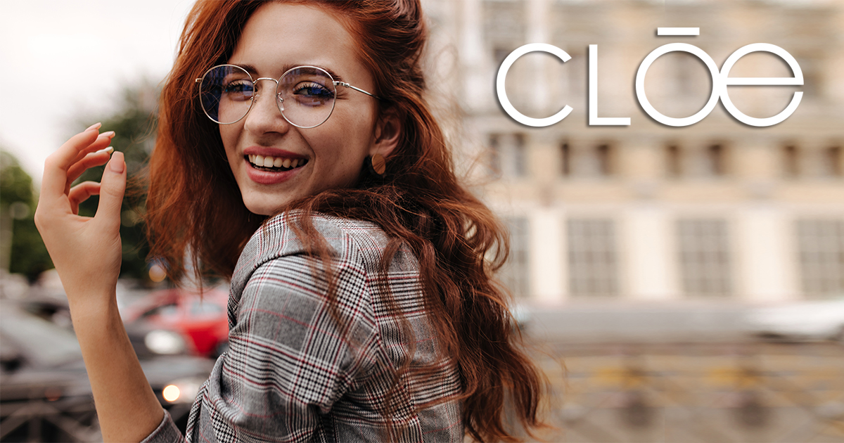 Cool girl in plaid outfit and eyeglasses smiling